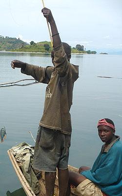 A young boy fishing in L. Kivu. REMA is making strides in lakeshore protection. Sunday Times/Timothy Kisambira.