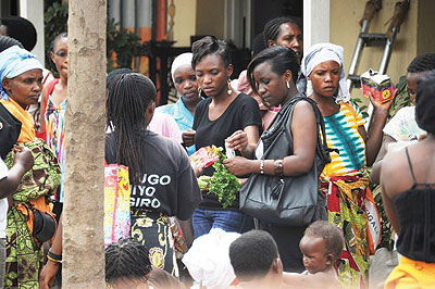 Women buy greens from a street vendor. Traders in Biryogo are complaining about street vendors u2018takingu2019 their clients. The New Times / Timothy Kisambira