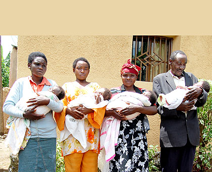 Nyirakanyana (2nd R) and her husband together with their older daughters hold the quadruplets. The New Times/ Courtesy.
