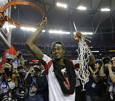 Louisville guard Kevin Ware holds the net after cutting it down following Louisville victory over Michigan in the NCAA title game. Net photo.