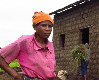 Mukankundiye in front of a house being built for her in Buhoro cell. The New Times/Jean Pierre Bucyensenge.