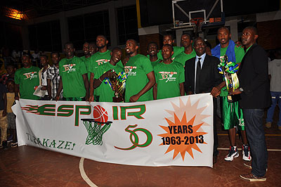 Espoir players and officials after winning the playoffs final trophy last month. The club is favourite to win the Gisembe memorial tournament in June. The New Times/P. Muzogeye.