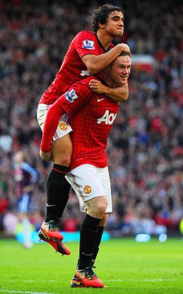 Manchester United Brazilian defender Rafael celebrates with team mate Wayne Rooney after scoring against Stoke City at Old Trafford. Net photo.