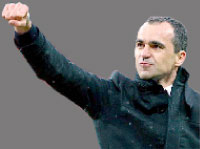 Wigan manager Roberto Martinez punches the air after victory. Net photo.