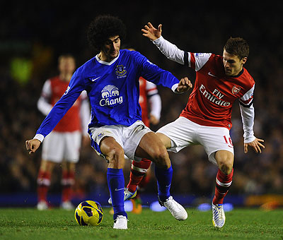 Everton's Marouane Fellaini  competes with Aaron Ramsey of Arsenal during the corresponding fixture at Goodison Park in November which ended 1-1. Net photo.