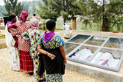 Survivors meditate by a mass grave at the Kigali Genocide Memorial Centre recently. The New Times/ John Mbanda.