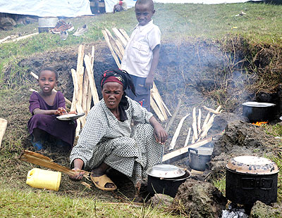 A refugee prepares a meal at Nkamira transit centre last year.  The New Times/ File.