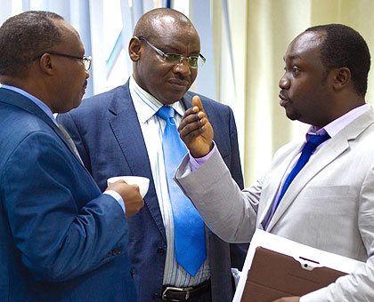 L-R: Cabinet Affairs minister Protais Musoni, Finance Minister Gatete and State minister Evode Imena (Mining) chat at the Finance Ministry headquarters in Kigali yesterday.  The New Ti....