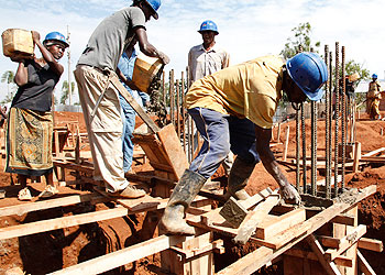 Masons working on a construction site. Infrastructure minister Lwakabamba has said the engineers regulator should enforce standards. The New Times/File.