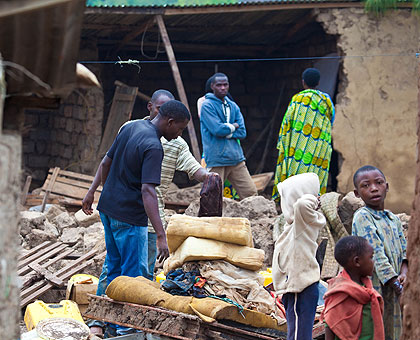 A family, whose house was destroyed by rain in Gatsata sector recently, tries to salvage some property from the rubble.   The New Times/T. Kisambira. 