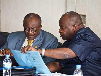 Saadall (R) chats with Bageine during the council meeting. The New Times /Timothy Kisambira. 