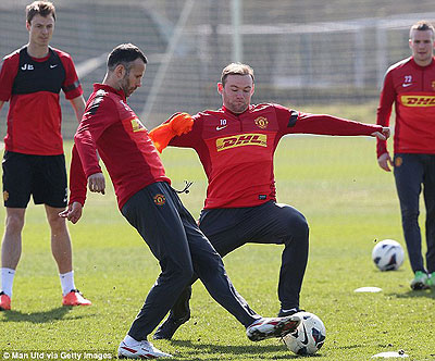 Wayne Rooney flies into a tackle on Ryan Giggs in Manchester United's training ahead of Monday's game against Villa. Net photo.