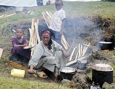 A refugee from Congo prepares a meal at Nkamira transit centre in Gisenyi. The New Times /T. Kisambira.