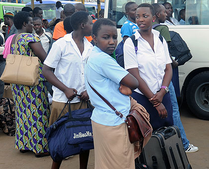 STRANDED: Students wait for transport to school at Nyabugogo Bus Terminal yesterday. Education officials say about 90 per cent of the student population returned to school as the secon....