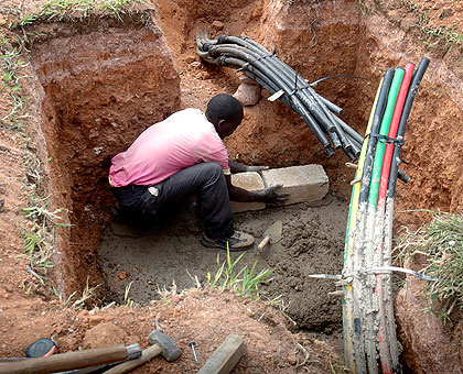 A man at work during the laying of the optic cable across the country in the past. KDN has already laid a 120 kilometre fibre link from Nairobi to Namanga and will proceed to Rwanda. The New Times/ File.