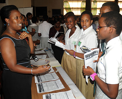 An IT expert talks to school girls during the Girls in ICT Day in Kigali on Thursday. The New Times/ John Mbanda. 