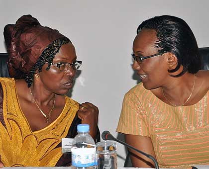 Speaker of Parliament Rose Mukantabana (R) chats with Pan-African Parliament vice president Juliana Kantengwa at the closing ceremony of a continental parliamentary session on land and agriculture in Kigali on Saturday. African lawmakers resolved to strengthen existing laws at national and regional level to prevent fraudulent land deals on the continent.   New Times/  John Mbanda.