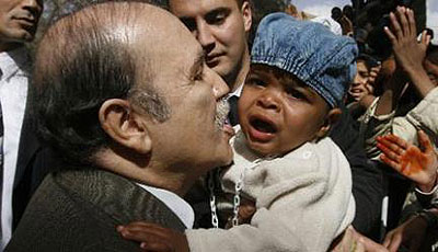 lgeriau2019s President Abdelaziz Bouteflika kisses a baby during his official visit to the southern city of Tamanrasset in a January 7, 2008. Net photo.