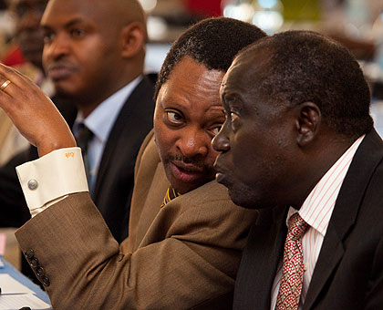 Prof. Shyaka (L) chats with Justice Minister Karugarama during the World Press Day meeting yesterday. The New Times Timothy Kisambira. 
