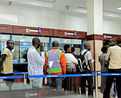 Clients queue to transact in a bank in Kigali. With a piggy bank, Rutunga residents have a future. The New Times/ File.
