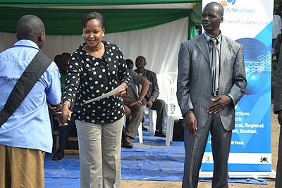 Mbabazi (C)  awards a certificate to one of the Iwawa trainees after completing the course last Saturday. The New Times/ JP Bucyensenge. 