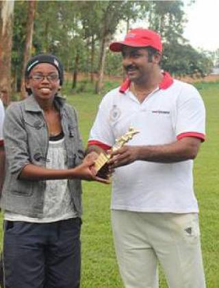 Mary Maina (left) receives her trophy for Woman players of the tournament. The New Times Sports / Courtesy.