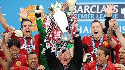 Sir Alex Ferguson lifts the Premier League trophy for the final time.