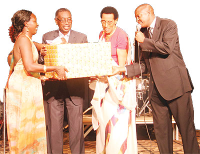 Maria Yohana Mukankuranga (2nd from the right), accepts the prize for Mother of the Year, from The New Timesu2019  Sales and Marketing Director David Mpanja (L), Senator Narcisse Musabeyezu and Eva Gara, the Managing Director of u2018The Pointu2019, the chief organiser of the event.