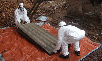 Technicians prepare asbestos roofs for disposal during a past exercise.   The New Times/ File.