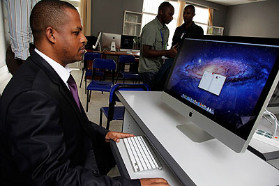 Gasana tests one of the new iMac Computers to be used at Rwanda Media Academy.    The New Times/ Timothy Kisambira.