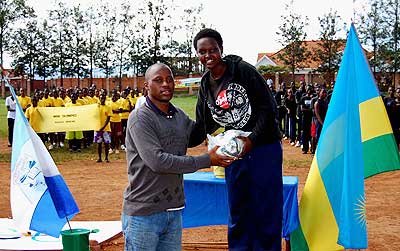 Belicia Mutesi  captain of 'Agata' receiving the award after her house won the girls' football competition. New Times / D. Mugisha.
