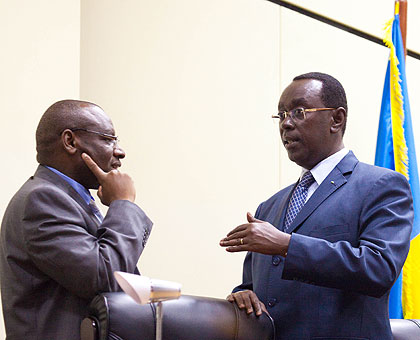 Finance minister Gatete (L)chats with Bernard Makuza, the Senate Vice president in charge of political affairs, before the session. The New Times/ Timothy Kisambira.