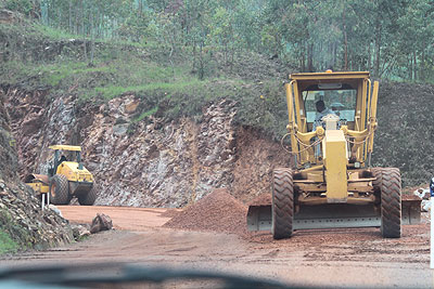 Graders level the surface at a road construction site recently. Rutsiro District wants to develop its feeder roads.    The New Times/ File.