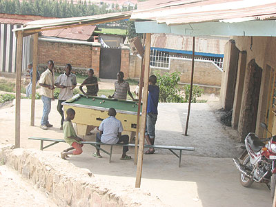 Residents playing pool at a local pub.
