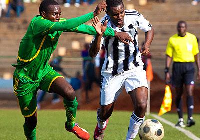 APR full back Albert Ngabo tries to maneuver his way past an AS Kigali defender during yesterdayu2019s Peace Cup semi-final match at Stade de Kigali. Sunday Sport/T. Kisambira.