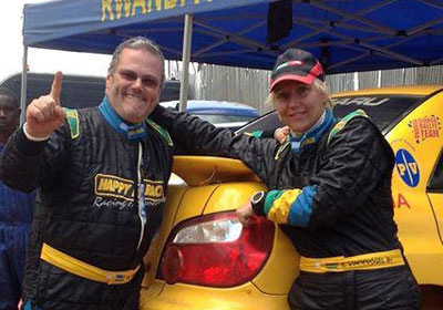Giancarlo Davite and his navigatro Sylvia Vindevogel pose for the cameras after winning the Huye rally at the weekend. The New Times / Courtesy