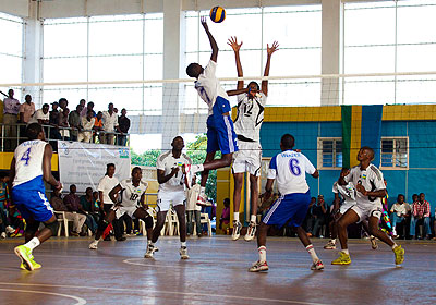 INATEKu2019s Marchal Pierre Kwizera goes for a spike as APR and U-21 national team center Fred Musoni tries to block him during the final of the Genocide Memorial Tournament.