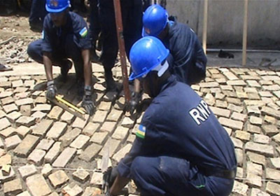 RWAFPU officers lay tiles at the compound of Prison Civile de Jeremie. Courtesy.