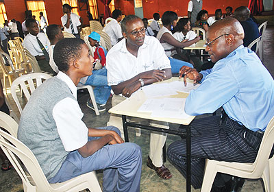 A teacher of Riviera High School discussing with a parent and a student. The New Times/ Allan Brian Ssenyonga
