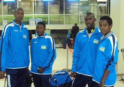 Rwandau2019s beach volleyball teams, men and women at the Kigali Intu2019l Airport before jetting out of to Poland. The New Times / P. Kamasa.