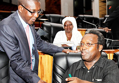 Juvenal Nkusi, president of PAC (R) chats with Evariste Kalisa, the deputy Speaker before the beginning of the session. The New Times/ T. Kisambira.