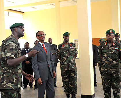 Maj. David Kanamugire (L), one of the college graduates, guides President Kagame on a tour of the RDF Command and Staff College yesterday. Lt. Gen. Charles Kayonga (C), the Chief of Defence Staff, and college commandant Brig. Gen. Jean Jacques Mupenzi (R) look on. The New Times/ Village Urugwiro.