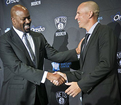Brooklyn Nets general manger Billy King, left, shakes hands with new coach Jason Kidd after an NBA basketball news conference introducing Kidd Thursday.  Net photo.