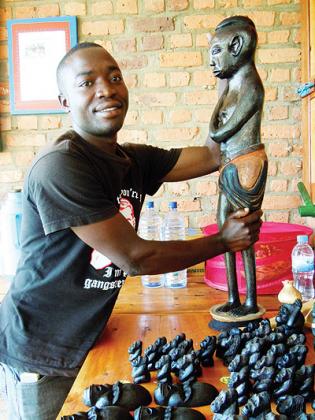 Rukundo shows off one of his carvings.  Saturday Times/Moses Opobo