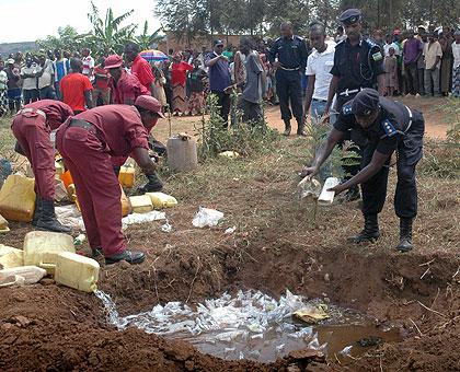 Police and local defence forces destroy illicit brew. The Sunday Times/File