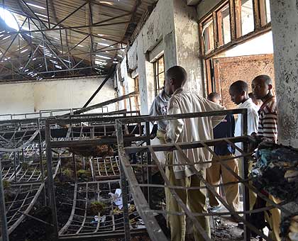 Students stare at what remained of a dormitory after one of the fires gutted Byimana School of Sciences. The New Times/ File. 