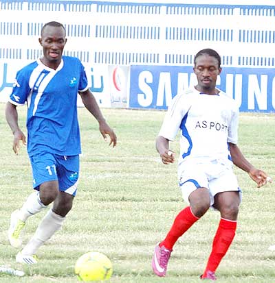 Cedric Amissi (L) chases the ball with Ports' Fabrice Manirambona. The Burundian scored a hat trick for Rayon Sports, who came from behind to win 4-1. The New Times / B. Mugabe.