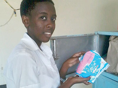 Emmanuella Margot Mutesi, Prefect of Gender at IFAK, shows where they keep the sanitary pads at school. The New Times/D. Umutesi
