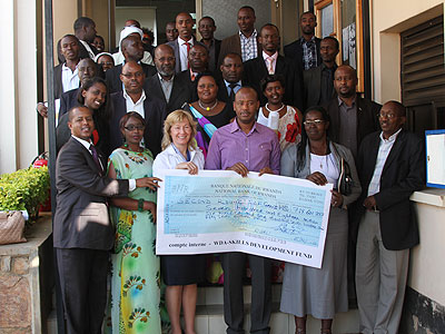 Nsengiyumva (C) poses in a group photo with the grantees. The New Times/S. Babijja