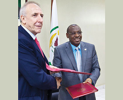 Amb. Gatete and DFIDu2019s Hammond exchange documents after the signing ceremony yesterday. The New Times/ Timothy Kisambira. 